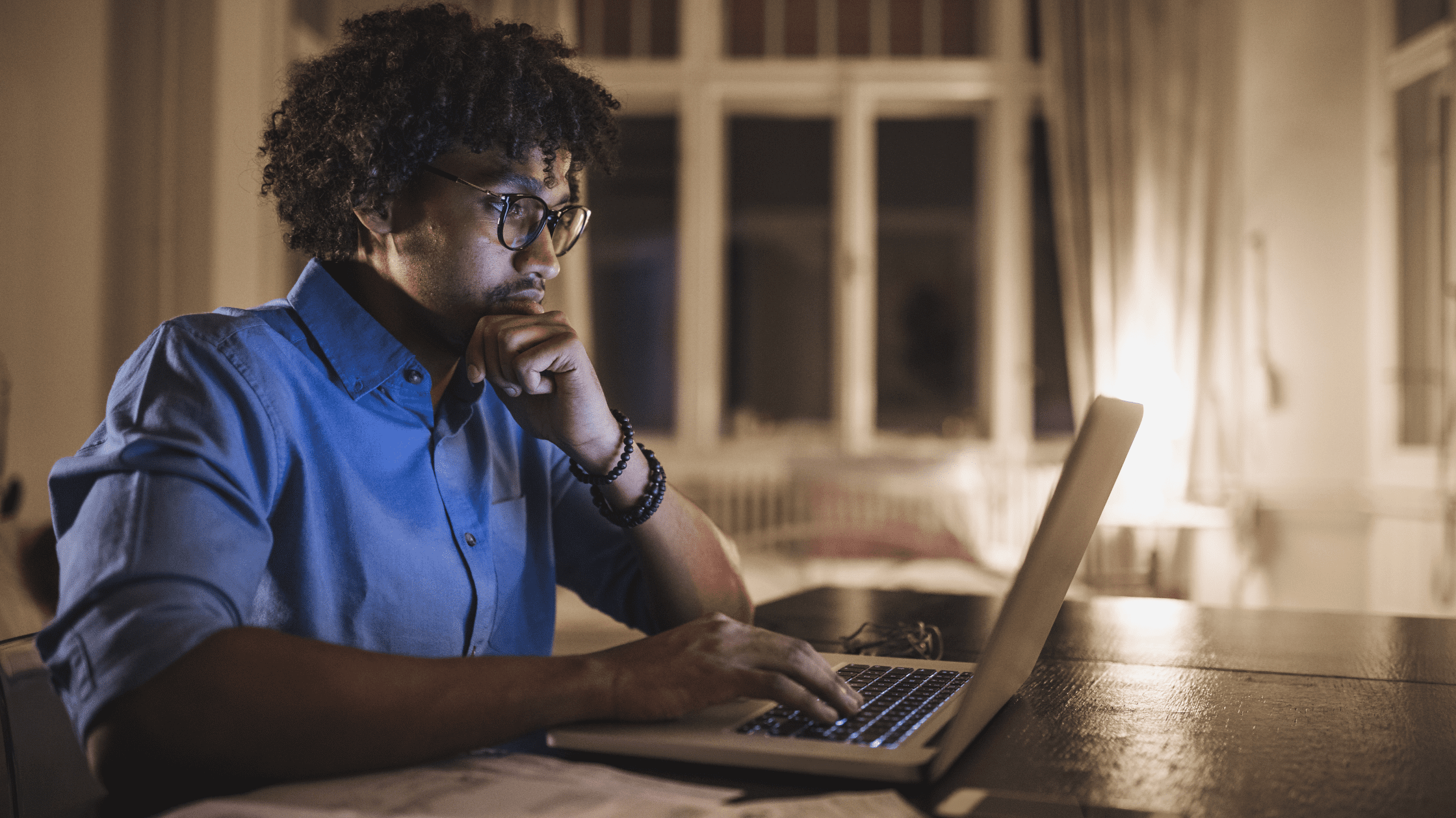 A medical school student studying for the USMLE Step 3 at home on his laptop.